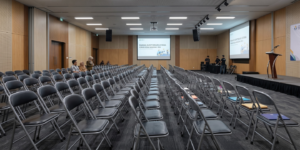 A large auditorium office filled with folding chairs